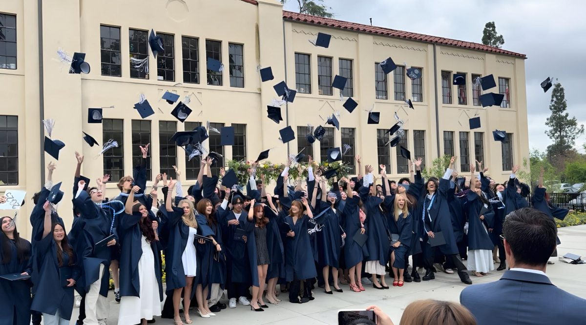 EF graduates toss their caps in the air after the graduation ceremony.