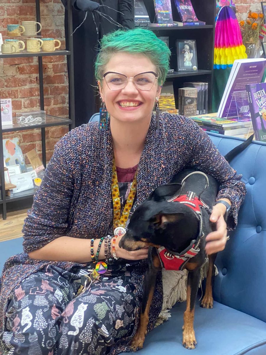 Kealie Mardell-Carrera, co-owner of Underdog Bookstore, poses with her beloved dog.
