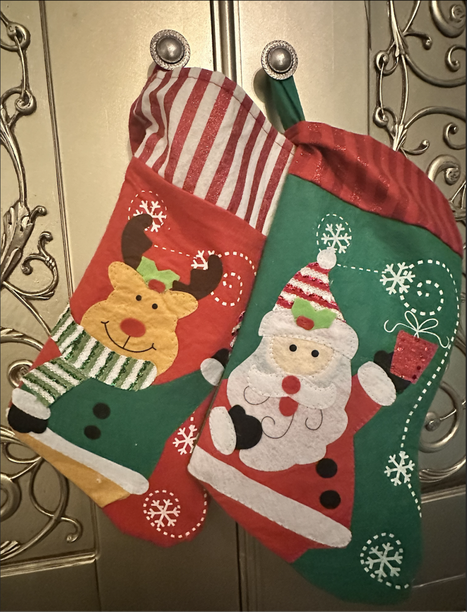 Two stockings; one reindeer-themed and one Santa-themed.